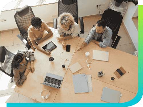 Top view of colleagues at a desk brainstorming